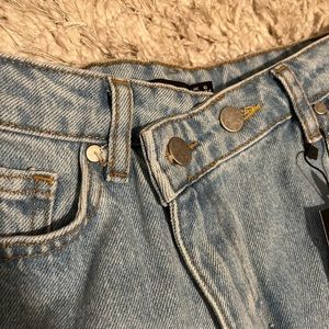 Asymmetrical envelope style blue jeans